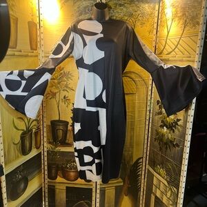 Elegant Black and White Bell Sleeve Dress with peek a boo slit in the back.